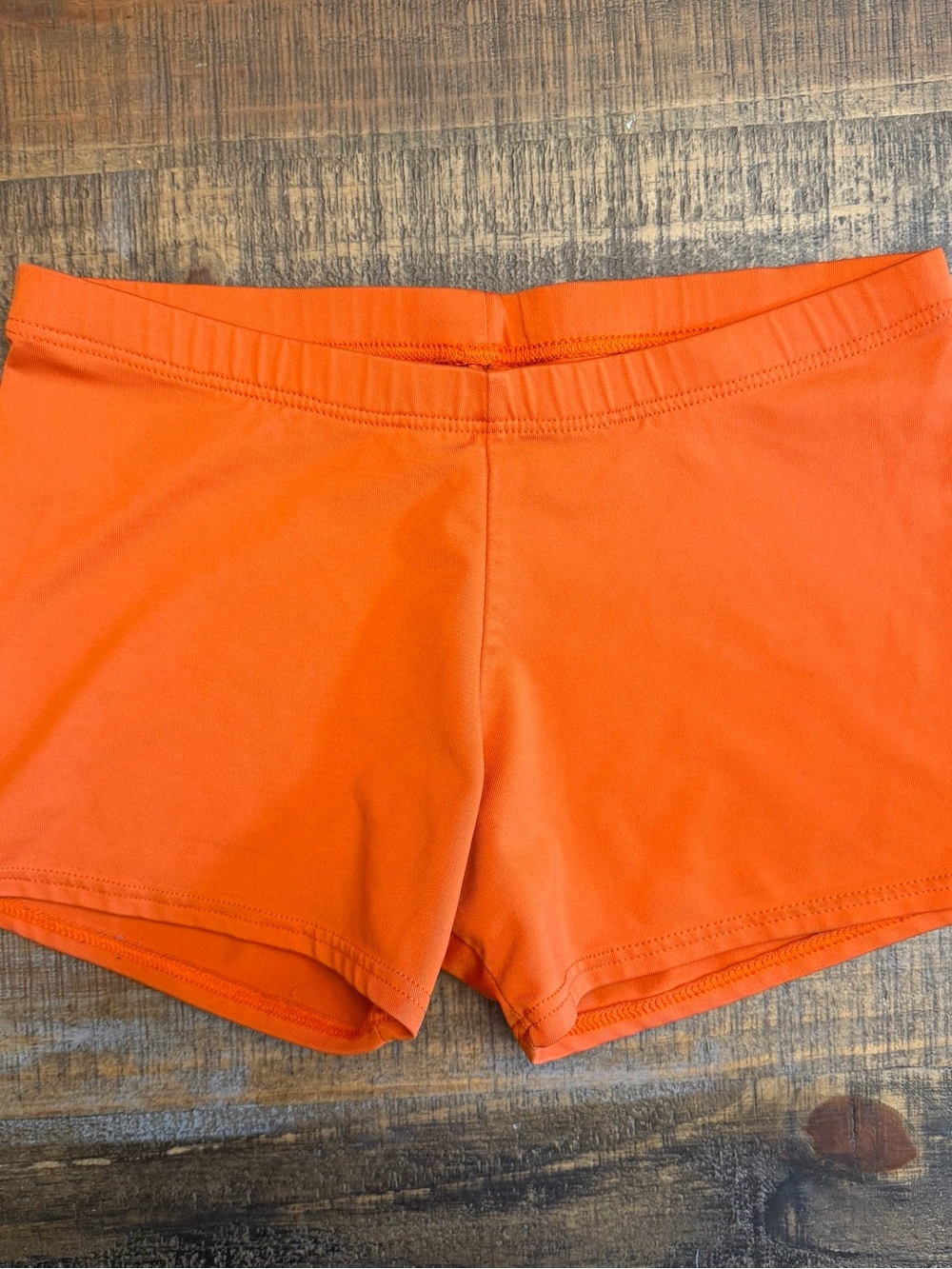 Women’s motionwear orange micro mini spandex shorts